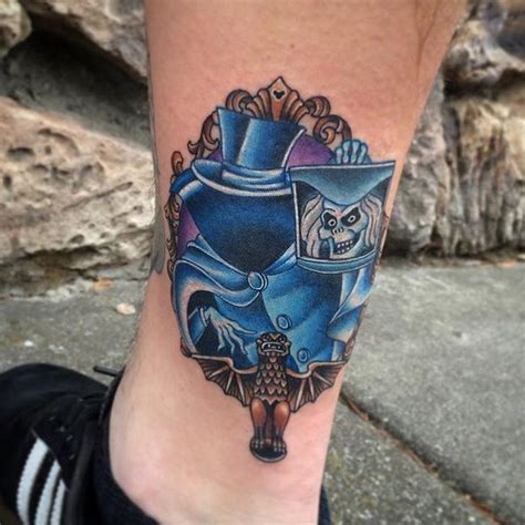 Tattoo of a haunted ghost with a witch hat